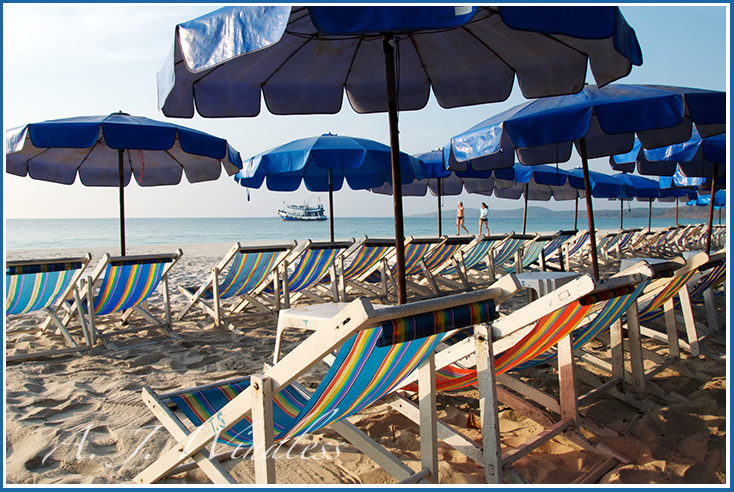 Rows of empty beach chairs wait for the tourists to roll out of bed.