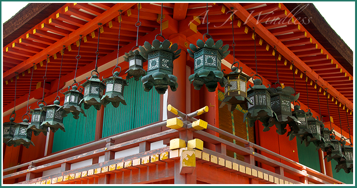 Japanese lanterns stretch in two directions as the wrap arouund this colorful temple.