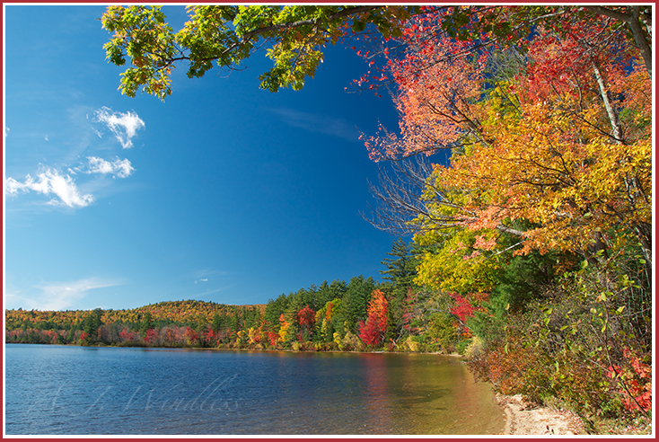 Autumn displays vivid colors along the shore of this tranquil New Hampshire lake.