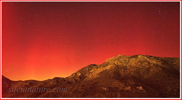 The red glow and streaks of the aurora borealis near North Ogden.