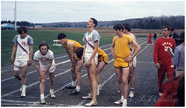 I stand at the starting line of the 880 yard dash, while Joe Sain, to my right stands several inches taller.