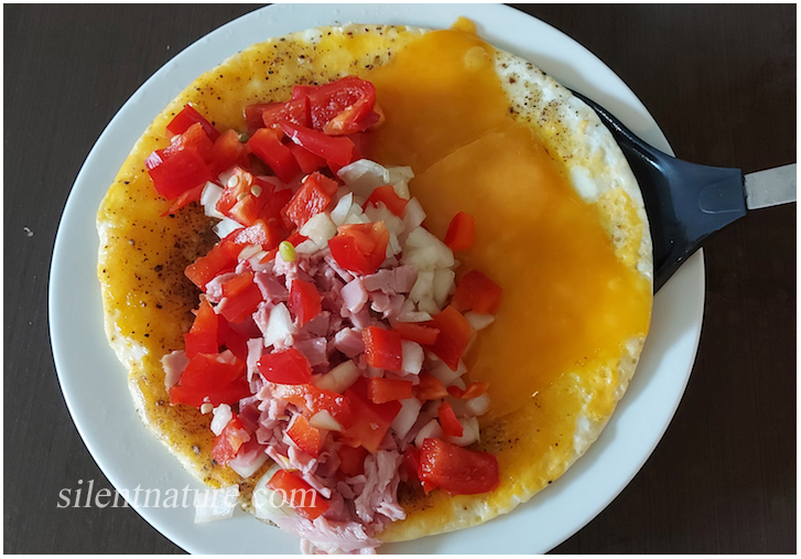 A beautiful cheese omelet in the process of being prepared.