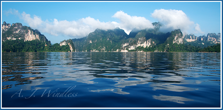These karst peaks seem to be drifting through the clouds as reflections bounce around on the water.