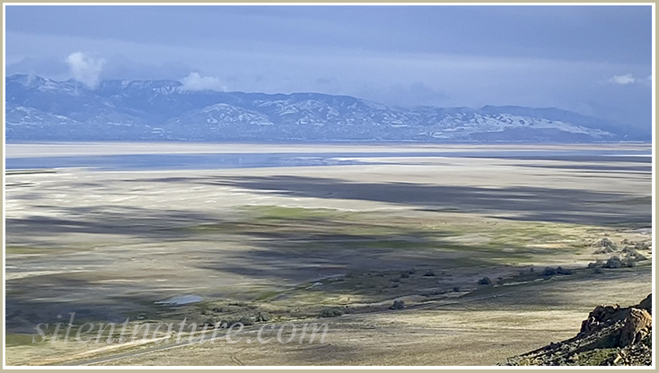 A view of The Great Salt Lake from Antelope Island showing more dry bed than water.