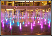 Thumbnail for the blue and magenta lit water fountain with small arches.