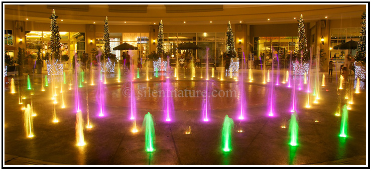 The third in a series of six photos of the water fountain colored with lights and synchronized to classical music.