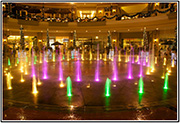 Thumbnail for the water fountain as lit by yellow, green, and magenta lights.