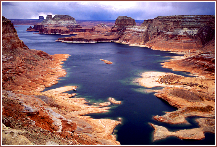 Stunning photo of a houseboat hidden in the secluded walls and waters of Lake Powell.