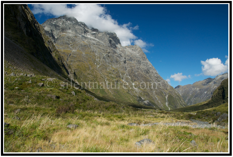 The sweeping curves of this mountain are accentuated by the moving shadows.