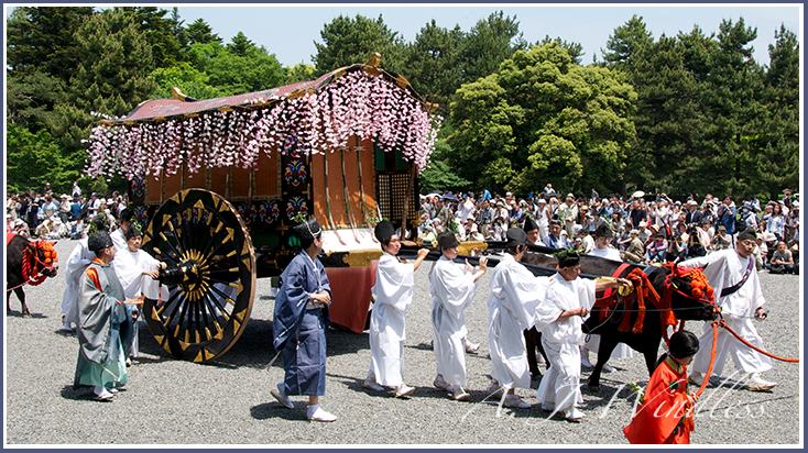 Japanese participants escort a traditional carriage in a Kyoto parade.