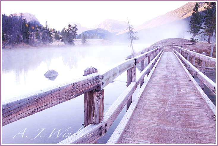 With fog drifting across the lake, a wooden bridge is completely frosted. 